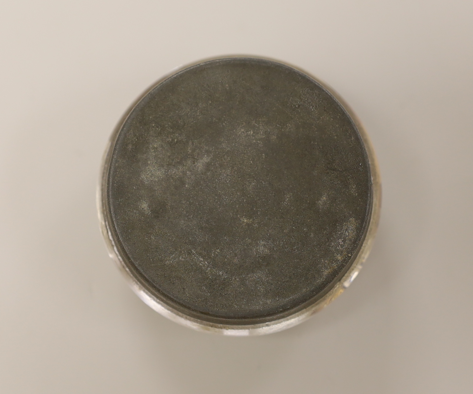 A pinchbeck figural paperweight, approximately 6cm diameter